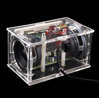Angled view of DIY Bluetooth stereo speaker kit with clear acrylic casing and exposed electronic components.