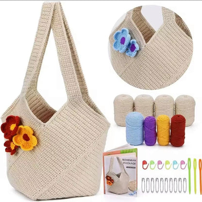 Cream crocheted shoulder bag with red and yellow flower appliqués beside yarn, hook, stitch markers and kit instructions.