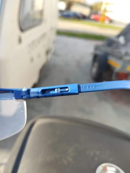 Close-up of the adjustable blue side arm on a pair of clear safety glasses.
