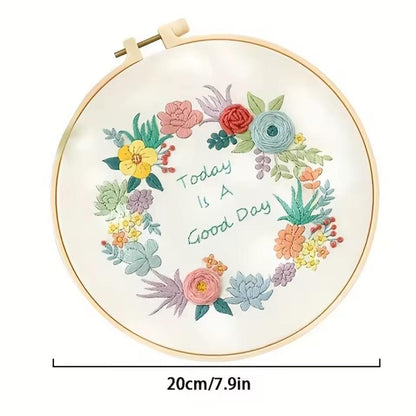 Round 20 cm floral embroidery hoop with a stitched flower wreath surrounding the words Today Is A Good Day.