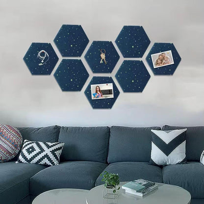 Seven dark blue hexagon felt memo boards with stars and small pinned photos above a sofa.