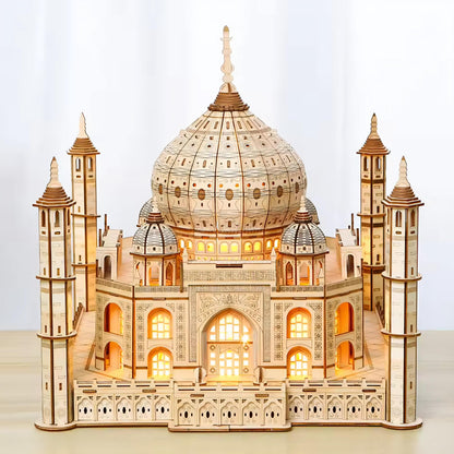 Front view of illuminated Taj Mahal 3D wooden model with symmetrical arches and four towers.