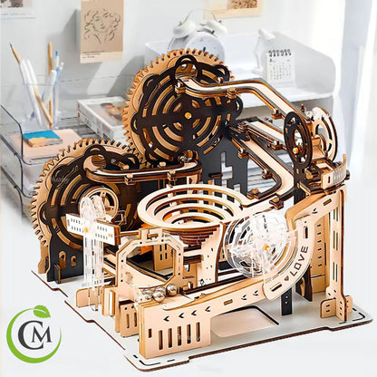 Assembled mechanical wooden marble run model with large gear wheels, spiral bowl, metal balls and sloping marble tracks.