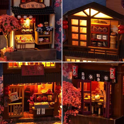 Japanese Sakura Alley book nook close-ups of tiny illuminated street shops and pink trees.