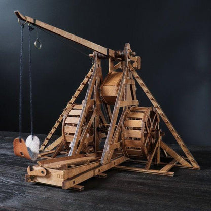Wooden medieval trebuchet model front view showing throwing arm and hanging sling.