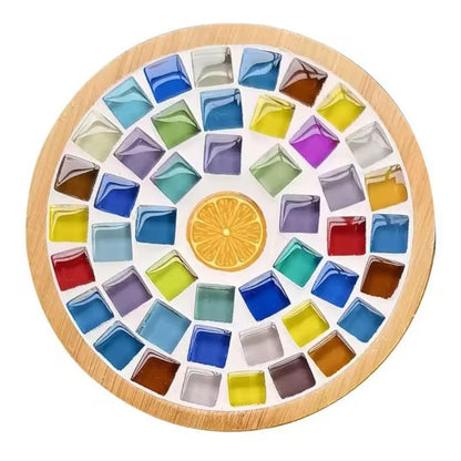 Round bamboo mosaic coaster with multicoloured square glass tiles arranged around an orange slice illustration