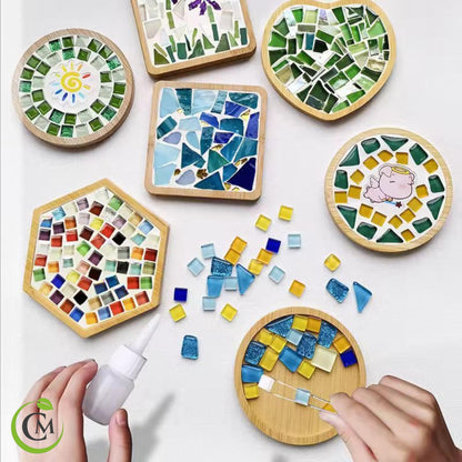 DIY mosaic coaster and tray kit showing finished bamboo mosaic coasters, loose coloured glass tiles and hands assembling a coaster
