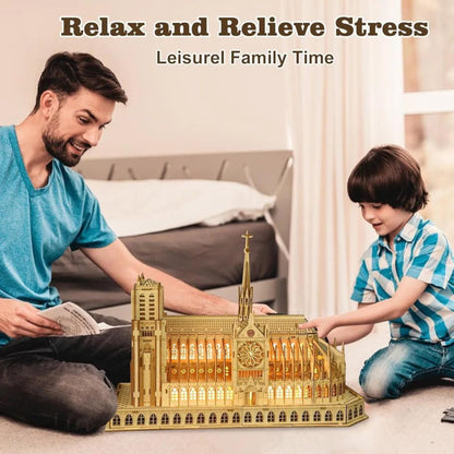 Adult and child displaying an illuminated wooden Notre Dame cathedral puzzle together on the floor.