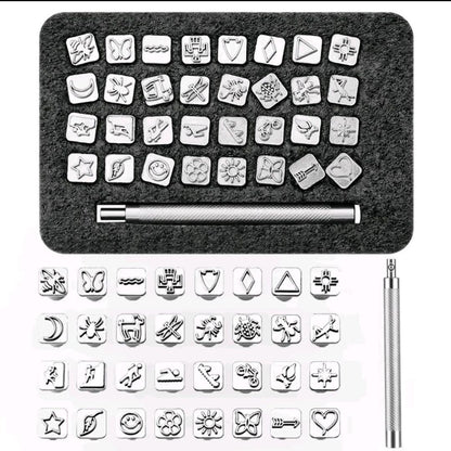 Thirty-two metal leather stamp designs arranged in foam tray with holder showing butterfly, heart and stars.