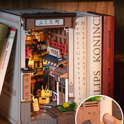 Side view of Sakura Wine Alley book nook showing narrow Japanese street and miniature building façades.