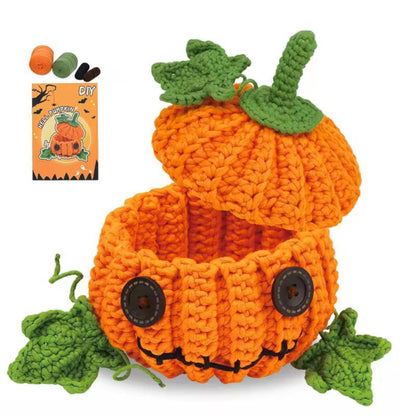 Orange crochet jack-o-lantern pumpkin container with green leaves and black button eyes.