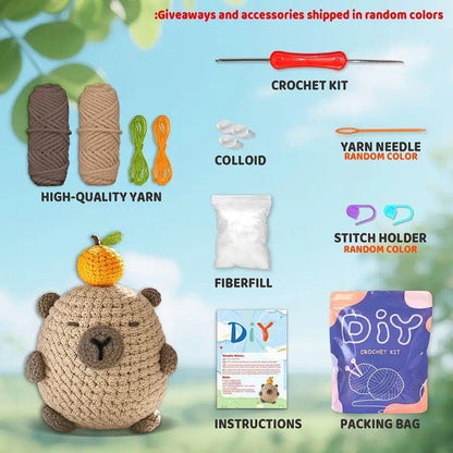 Capybara crochet kit contents with brown and beige yarn, orange and green strands, stuffing, hook and instructions.