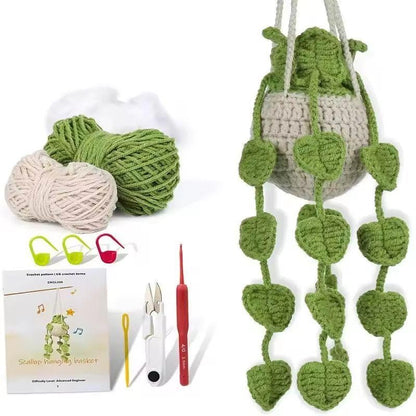 Crocheted hanging planter with large heart-shaped green leaves and starter kit materials.