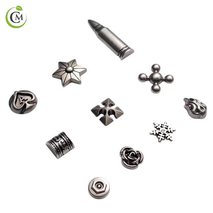Ten decorative silver metal rivets including star, flower, flame and geometric shapes.