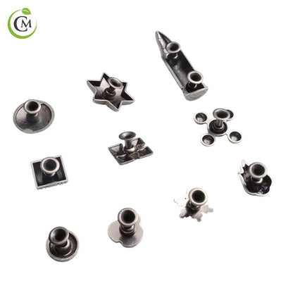 Underside of decorative metal rivet caps showing fastening stems and backs.