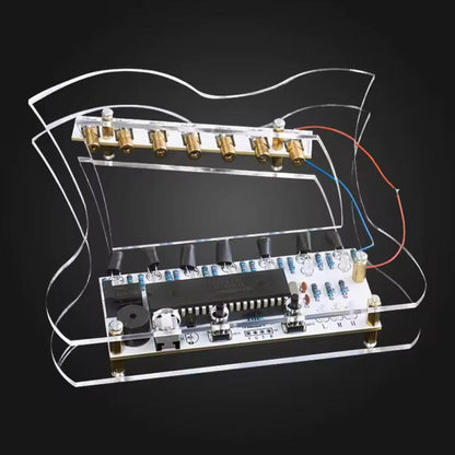 Side view of transparent laser harp showing curved acrylic frame and electronic soldered component board.