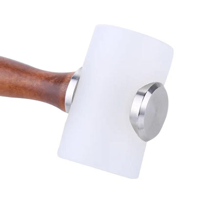 Close-up of white nylon mallet head with silver metal fittings and brown wooden handle.