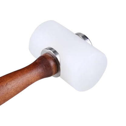 Angled close-up of white nylon mallet head attached to brown wood handle with metal collar.